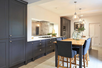 Inspiration for a medium sized contemporary galley open plan kitchen in Other with a double-bowl sink, shaker cabinets, grey cabinets, quartz worktops, grey splashback, glass sheet splashback, black appliances, ceramic flooring, an island, beige floors and white worktops.