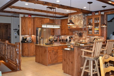 Eat-in kitchen - mid-sized rustic l-shaped ceramic tile eat-in kitchen idea in Little Rock with raised-panel cabinets, medium tone wood cabinets, granite countertops, beige backsplash, ceramic backsplash, stainless steel appliances and an island