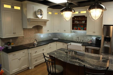 Example of a mid-sized l-shaped enclosed kitchen design in Boston with an island