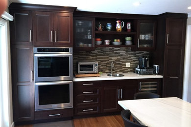 Eat-in kitchen - large transitional l-shaped medium tone wood floor eat-in kitchen idea in San Francisco with a drop-in sink, shaker cabinets, dark wood cabinets, marble countertops, multicolored backsplash, matchstick tile backsplash, stainless steel appliances and an island