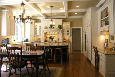 Medium tone wood floor kitchen photo in Salt Lake City with white cabinets and an island