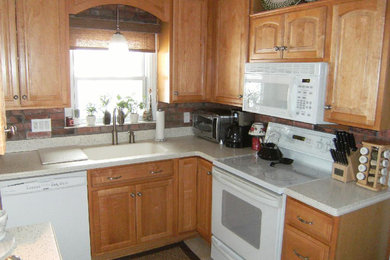 Mid-sized kitchen photo in Orlando with light wood cabinets