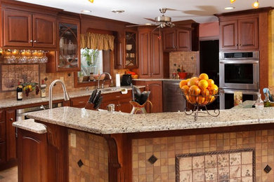 Inspiration for a mid-sized transitional l-shaped slate floor and multicolored floor open concept kitchen remodel in Other with a double-bowl sink, raised-panel cabinets, dark wood cabinets, quartz countertops, beige backsplash, stone tile backsplash, stainless steel appliances and an island