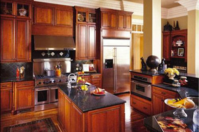 Kitchen - kitchen idea in Austin with granite countertops, gray backsplash, stainless steel appliances and an island