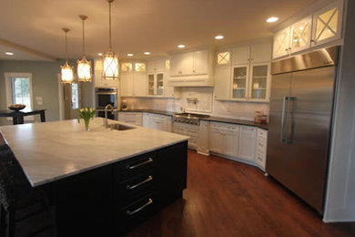 Kitchen - traditional medium tone wood floor kitchen idea in Indianapolis with white cabinets and stainless steel appliances