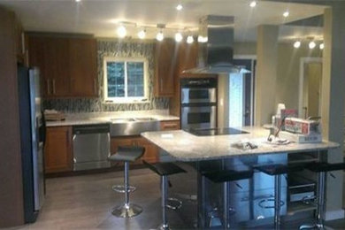 Example of a medium tone wood floor kitchen design in Other with medium tone wood cabinets, stainless steel appliances and an island