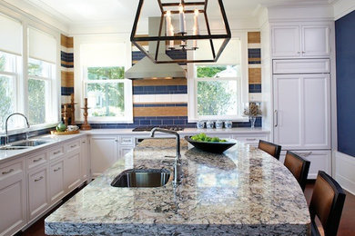 Large transitional l-shaped dark wood floor and brown floor eat-in kitchen photo in Other with a double-bowl sink, recessed-panel cabinets, white cabinets, granite countertops, multicolored backsplash, porcelain backsplash, paneled appliances and an island
