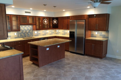 Example of a mid-sized minimalist u-shaped open concept kitchen design in Miami with an undermount sink, shaker cabinets, dark wood cabinets, granite countertops, glass tile backsplash, stainless steel appliances and an island