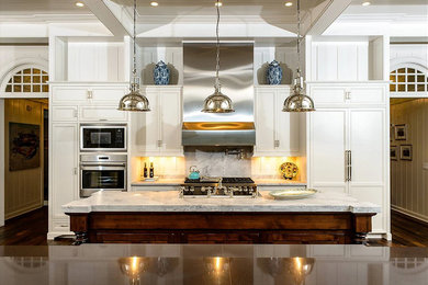 Open concept kitchen - large traditional u-shaped dark wood floor and brown floor open concept kitchen idea in Atlanta with an undermount sink, recessed-panel cabinets, white cabinets, marble countertops, gray backsplash, marble backsplash, stainless steel appliances and an island