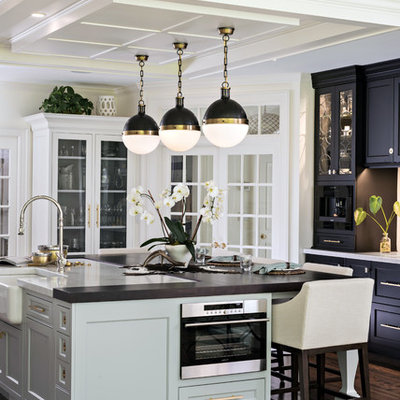 Kitchen - traditional dark wood floor and brown floor kitchen idea in Boston with a farmhouse sink, shaker cabinets, black cabinets and an island