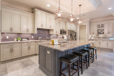 Large transitional single-wall porcelain tile and gray floor eat-in kitchen photo in New Orleans with an undermount sink, raised-panel cabinets, beige cabinets, granite countertops, gray backsplash, subway tile backsplash, stainless steel appliances and an island