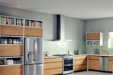 Inspiration for a medium sized l-shaped open plan kitchen in Phoenix with flat-panel cabinets, light wood cabinets, green splashback, metro tiled splashback, stainless steel appliances and no island.