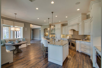 Example of a mid-sized transitional galley medium tone wood floor eat-in kitchen design in Nashville with an undermount sink, beaded inset cabinets, white cabinets, granite countertops, beige backsplash, porcelain backsplash, paneled appliances and an island