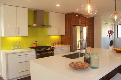 Example of a small trendy galley concrete floor eat-in kitchen design in Los Angeles with a single-bowl sink, flat-panel cabinets, white cabinets, quartzite countertops, green backsplash, stainless steel appliances and an island