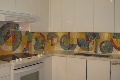 Mid-sized minimalist l-shaped ceramic tile kitchen photo in Toronto with a double-bowl sink, flat-panel cabinets, white cabinets, mosaic tile backsplash and white appliances
