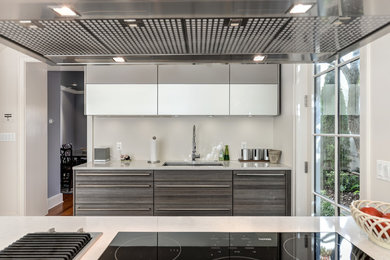 Example of a kitchen design in DC Metro with stainless steel appliances and an island