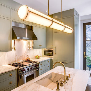 Medium sized classic l-shaped kitchen in DC Metro with an integrated sink, flat-panel cabinets, green cabinets, stainless steel appliances, light hardwood flooring, an island, brown floors and quartz worktops.