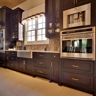 Example of a mid-sized arts and crafts l-shaped ceramic tile eat-in kitchen design in Charlotte with dark wood cabinets, granite countertops, stainless steel appliances, an island, a farmhouse sink, recessed-panel cabinets, brown backsplash and matchstick tile backsplash