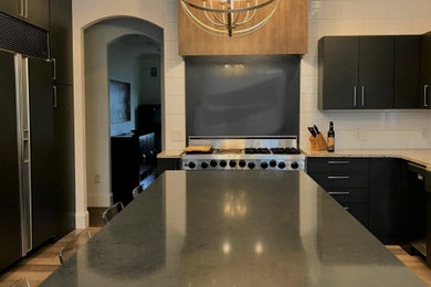 Photo of a large modern l-shaped kitchen.