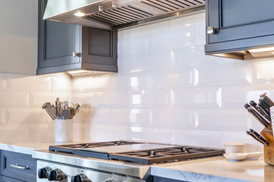 Example of a trendy kitchen design in San Diego with beaded inset cabinets, gray cabinets, quartz countertops, white backsplash, ceramic backsplash, stainless steel appliances and turquoise countertops