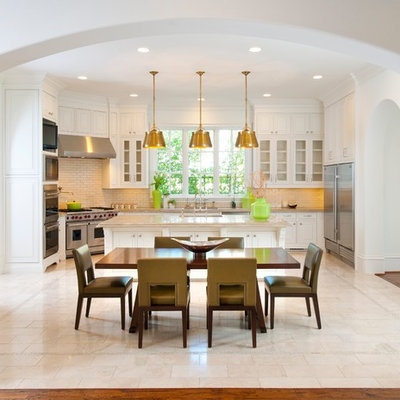 Tuscan eat-in kitchen photo in Dallas with glass-front cabinets, white cabinets and stainless steel appliances