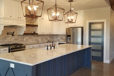 Kitchen pantry - large cottage l-shaped concrete floor and gray floor kitchen pantry idea in Dallas with a farmhouse sink, raised-panel cabinets, white cabinets, quartzite countertops, gray backsplash, brick backsplash, stainless steel appliances, an island and gray countertops