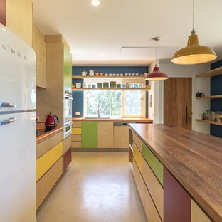 This is an example of a mid-sized contemporary l-shaped eat-in kitchen in Canberra - Queanbeyan with a double-bowl sink, flat-panel cabinets, light wood cabinets, with island, orange benchtop, white appliances and beige floor.