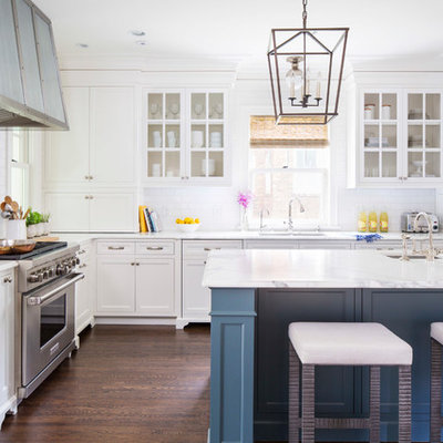 Elegant l-shaped dark wood floor kitchen photo in Minneapolis with an undermount sink, white cabinets, white backsplash, subway tile backsplash, stainless steel appliances, an island, marble countertops and recessed-panel cabinets