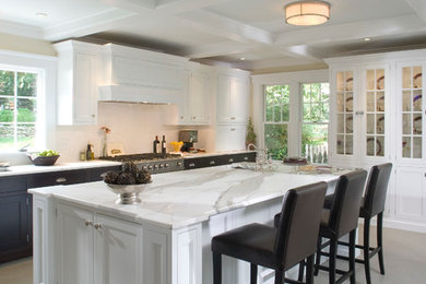 Elegant u-shaped eat-in kitchen photo in New York with an undermount sink, flat-panel cabinets, white cabinets, marble countertops, ceramic backsplash and stainless steel appliances