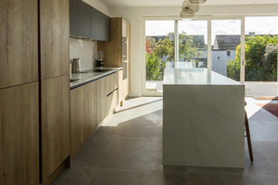 Large contemporary kitchen in Dublin with marble worktops and an island.