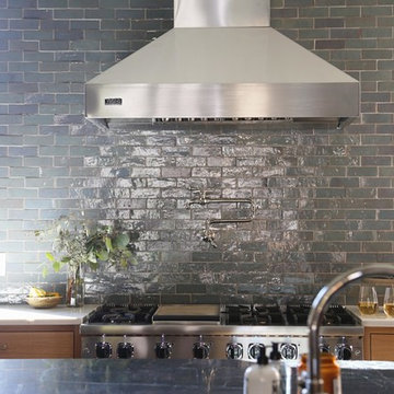 glazed terracotta subway tile is the center of attention in this kitchen remodel
