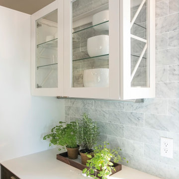Glazed Wall Unit with Exposed White Bio-composite Frames and Glass Shelves.