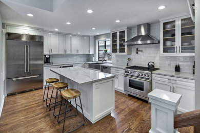 This is an example of a traditional kitchen in San Francisco with shaker cabinets, white cabinets and stainless steel appliances.