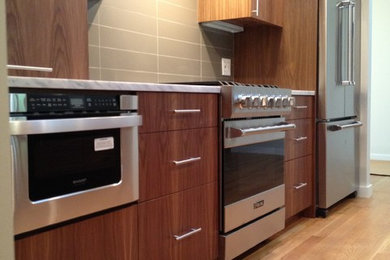 Kitchen - modern kitchen idea in Denver with marble countertops, stainless steel appliances and an island