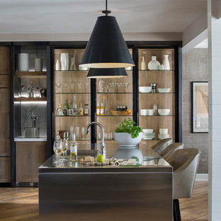 This is an example of a mid-sized transitional kitchen in Other with stainless steel benchtops, with island, an integrated sink, medium hardwood floors and open cabinets.