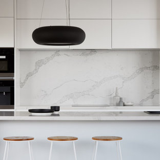Design ideas for a mid-sized contemporary galley eat-in kitchen in Melbourne with a single-bowl sink, open cabinets, white cabinets, marble benchtops, white splashback, marble splashback, black appliances, with island and white benchtop.