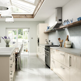 Inspiration for a large traditional single-wall eat-in kitchen in Other with a double-bowl sink, flat-panel cabinets, beige cabinets, laminate benchtops, blue splashback, subway tile splashback, coloured appliances, porcelain floors, with island and white floor.