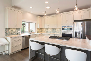 Example of a large transitional l-shaped dark wood floor eat-in kitchen design in Other with an undermount sink, shaker cabinets, white cabinets, quartz countertops, blue backsplash, glass tile backsplash, stainless steel appliances, an island and white countertops