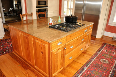 Example of a large classic u-shaped medium tone wood floor open concept kitchen design in Richmond with raised-panel cabinets, granite countertops and stainless steel appliances
