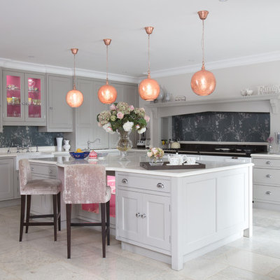 Example of a mid-sized transitional l-shaped gray floor enclosed kitchen design in Surrey with beaded inset cabinets, gray cabinets, gray backsplash, an island, white countertops, limestone countertops and black appliances