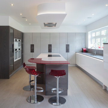 Gloss and wood kitchen with red breakfast bar