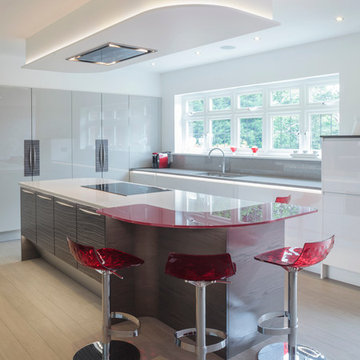 Gloss and wood kitchen with red breakfast bar