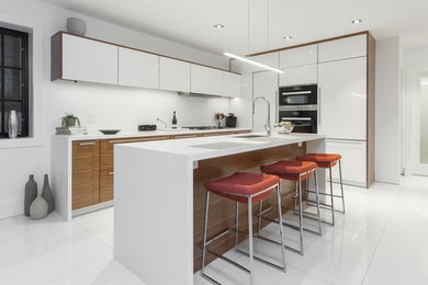 Small trendy white floor eat-in kitchen photo in Toronto with white backsplash, stainless steel appliances, an island and white countertops