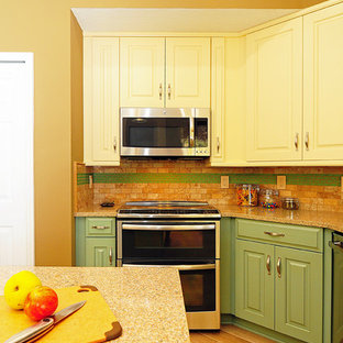 Photo of a mid-sized eclectic u-shaped open plan kitchen in Orlando with an undermount sink, raised-panel cabinets, green cabinets, quartz benchtops, beige splashback, stone tile splashback, stainless steel appliances, porcelain floors and with island.