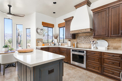 Inspiration for a southwestern l-shaped beige floor eat-in kitchen remodel in Phoenix with raised-panel cabinets, dark wood cabinets, multicolored backsplash, mosaic tile backsplash and an island