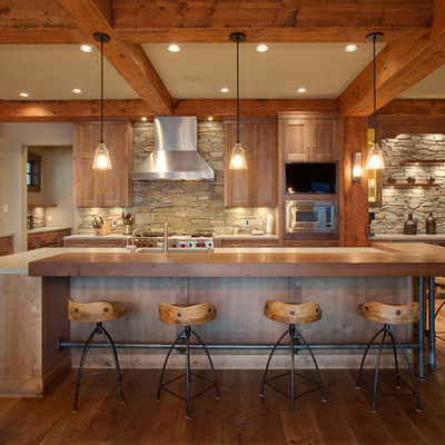 Inspiration for a large rustic galley medium tone wood floor kitchen remodel in Vancouver with shaker cabinets, light wood cabinets, wood countertops, stainless steel appliances, stone tile backsplash and an island