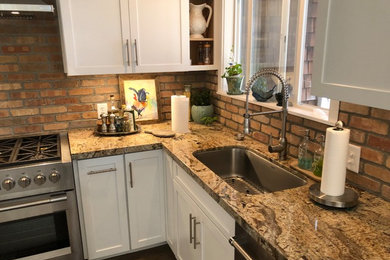 Eat-in kitchen photo in Other with an undermount sink, granite countertops, stone tile backsplash, stainless steel appliances and multicolored countertops