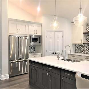 Mid-sized transitional open concept kitchen photos - Inspiration for a mid-sized transitional l-shaped dark wood floor and gray floor open concept kitchen remodel in Denver with a farmhouse sink, shaker cabinets, white cabinets, quartz countertops, multicolored backsplash, cement tile backsplash, stainless steel appliances, an island and white countertops