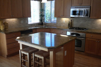 Kitchen - transitional kitchen idea in Portland with granite countertops