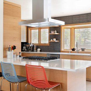 Small midcentury galley eat-in kitchen in Minneapolis with an undermount sink, flat-panel cabinets, light wood cabinets, quartzite benchtops, grey splashback, subway tile splashback, stainless steel appliances, porcelain floors, with island, grey floor and white benchtop.
